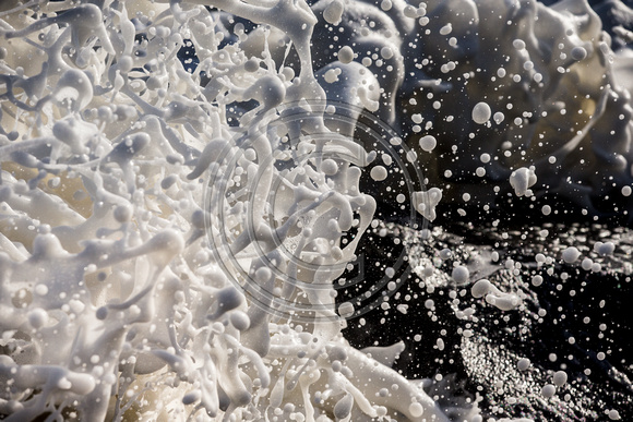 Foam from a wave exploding against a jetty rock - shot at 1/8000th of a second ...